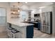 Modern kitchen with white cabinets, marble countertops and a farmhouse sink at 7311 Indigo Palms Way, Johns Island, SC 29455