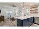 Open concept kitchen with a navy blue island and stainless steel appliances at 7311 Indigo Palms Way, Johns Island, SC 29455