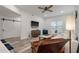 Open living area with hardwood floors, white sofa and a ceiling fan at 7311 Indigo Palms Way, Johns Island, SC 29455
