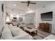 Living area features hardwood floors, white sofa and kitchen view at 7311 Indigo Palms Way, Johns Island, SC 29455