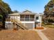 House with a screened porch and wooden deck at 804 E Ashley Ave, Folly Beach, SC 29439