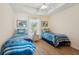 Bedroom with two twin beds, ceiling fan, and coastal decor at 804 E Ashley Ave, Folly Beach, SC 29439