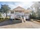 Two-story beach home with elevated deck, double garage, and spacious driveway at 804 E Ashley Ave, Folly Beach, SC 29439