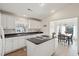 White kitchen with island, dark countertops, and ample cabinet space at 804 E Ashley Ave, Folly Beach, SC 29439