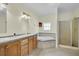 Bathroom with double vanity, corner tub, and shower at 8978 Victor Lincoln Rd, McClellanville, SC 29458
