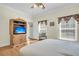 Bedroom featuring wood floors, large windows and a TV stand at 8978 Victor Lincoln Rd, McClellanville, SC 29458