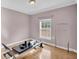 Simple bedroom with hardwood floors and large window at 8978 Victor Lincoln Rd, McClellanville, SC 29458