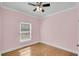 Simple bedroom with hardwood floors and a window at 8978 Victor Lincoln Rd, McClellanville, SC 29458