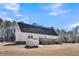 Rear view of house with deck and storage shed at 8978 Victor Lincoln Rd, McClellanville, SC 29458