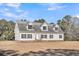 White house with gray roof, and a large yard at 8978 Victor Lincoln Rd, McClellanville, SC 29458