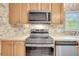 Kitchen features stainless steel appliances and wood cabinets at 8978 Victor Lincoln Rd, McClellanville, SC 29458