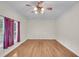 Bright living room with hardwood floors and ceiling fan at 8978 Victor Lincoln Rd, McClellanville, SC 29458