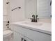 Modern bathroom featuring white cabinets, white quartz countertops, black hardware, and a shower-tub combo at 0 United Dr, Huger, SC 29450
