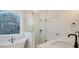 Luxurious bathroom with stand alone tub, glass shower, black fixtures and natural light at 0 United Dr, Huger, SC 29450