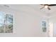 Bright bedroom with ceiling fan, tray ceilings, and tree views from large windows at 0 United Dr, Huger, SC 29450