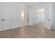 Spacious bedroom with wood flooring, white walls, white doors, and access to ensuite bathroom at 0 United Dr, Huger, SC 29450