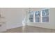 Dining area featuring wood floors, white walls, modern chandelier, and large windows with wooded view at 0 United Dr, Huger, SC 29450