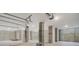 Spacious garage with concrete columns, cement walls, overhead lights, and garage door openers at 0 United Dr, Huger, SC 29450