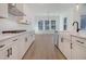 Stylish kitchen with island, white cabinets, stainless steel appliances, and hardwood floors at 0 United Dr, Huger, SC 29450
