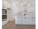 Modern kitchen features white cabinets, large island, stainless steel appliances, and pendant lighting at 0 United Dr, Huger, SC 29450