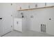 Bright laundry room with white cabinetry, marble-look flooring, and black hardware at 0 United Dr, Huger, SC 29450