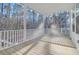 Beautiful screened in back porch with wood flooring and white columns overlooking a wooded lot at 0 United Dr, Huger, SC 29450