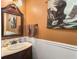 Small bathroom with an ornately framed mirror and eagle tapestry at 1001 Shinnecock Hills Ct, Summerville, SC 29483
