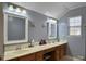Double vanity bathroom with light blue walls and wood cabinets at 1001 Shinnecock Hills Ct, Summerville, SC 29483