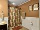 Bathroom with shower/tub combo and brown walls at 1001 Shinnecock Hills Ct, Summerville, SC 29483