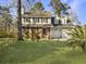 Two-story brick house with a large front yard, two-car garage, and mature trees at 1001 Shinnecock Hills Ct, Summerville, SC 29483