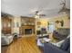 Large living room with hardwood floors, a stone fireplace, and mounted wildlife at 1001 Shinnecock Hills Ct, Summerville, SC 29483