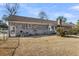 View of the brick house backyard showing the building's exterior and the property's yard at 101 Winston Cir, Summerville, SC 29485