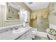 Bright bathroom with striped walls, elegant marble countertops, and a shower featuring glass doors at 101 Winston Cir, Summerville, SC 29485
