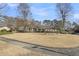 Well-maintained home with a spacious front yard, brick accents, and mature trees creating a peaceful setting at 101 Winston Cir, Summerville, SC 29485