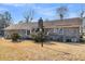 Brick home exterior showing windows, roofline, backyard shrubs, and lamp post at 101 Winston Cir, Summerville, SC 29485