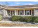 Inviting front porch with brick columns, a cozy seating area, and well-manicured hedges enhancing the entry at 101 Winston Cir, Summerville, SC 29485