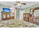 Charming main bedroom features light green walls, tropical print bedding, and traditional style furniture at 101 Winston Cir, Summerville, SC 29485