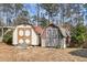 Rustic wooden sheds in a foliage filled backyard, showing extra outdoor storage at 101 Winston Cir, Summerville, SC 29485