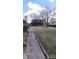 Spacious backyard with mature trees and a brick house with a chimney at 102 Barrington Blvd, Goose Creek, SC 29445