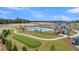 Aerial view of neighborhood pool, amenity center, putting green, and lake under construction at 108 Crosscut Ln, Summerville, SC 29486