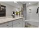 Well-lit bathroom with double sink vanity, modern fixtures, and a combination shower and tub at 108 Crosscut Ln, Summerville, SC 29486