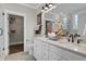 Well-lit bathroom with double sinks, white cabinets, and a walk-in closet at 108 Crosscut Ln, Summerville, SC 29486