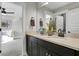 Well-lit double vanity bathroom with dark cabinetry, neutral countertops, and decorative plants at 108 Crosscut Ln, Summerville, SC 29486