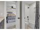 En-suite bathroom featuring a bathtub with shower and an adjacent bedroom with nautical decor at 108 Crosscut Ln, Summerville, SC 29486