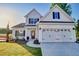 Charming two-story white home with an attached two-car garage and manicured landscaping at 108 Crosscut Ln, Summerville, SC 29486