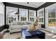 This modern living room has big windows for lots of natural light, and a cool blue ottoman at 108 Crosscut Ln, Summerville, SC 29486