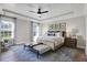 Beautiful main bedroom featuring tray ceiling, ceiling fan, en suite bathroom, and lots of natural light at 108 Crosscut Ln, Summerville, SC 29486