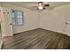Bright bedroom includes hardwood floors and a ceiling fan with light fixture at 133 Larson Dr, Summerville, SC 29485