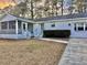 View of the home with a screened in porch and brick front on a landscaped lot at 133 Larson Dr, Summerville, SC 29485