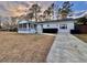 Lovely single-story home with a screened porch, green shrubbery, and a concrete driveway at 133 Larson Dr, Summerville, SC 29485